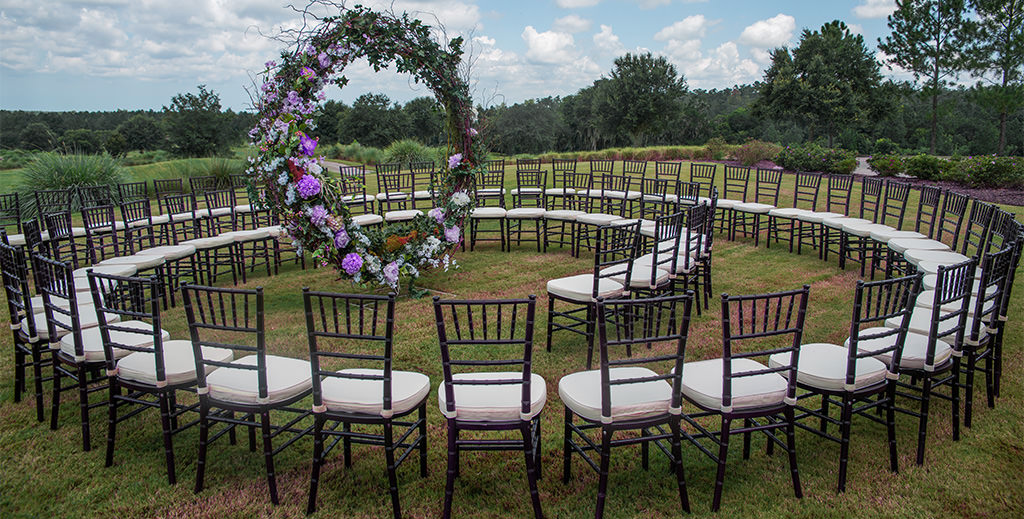 A wedding ceremony where the chairs are set in a circular spiral. A unique idea.