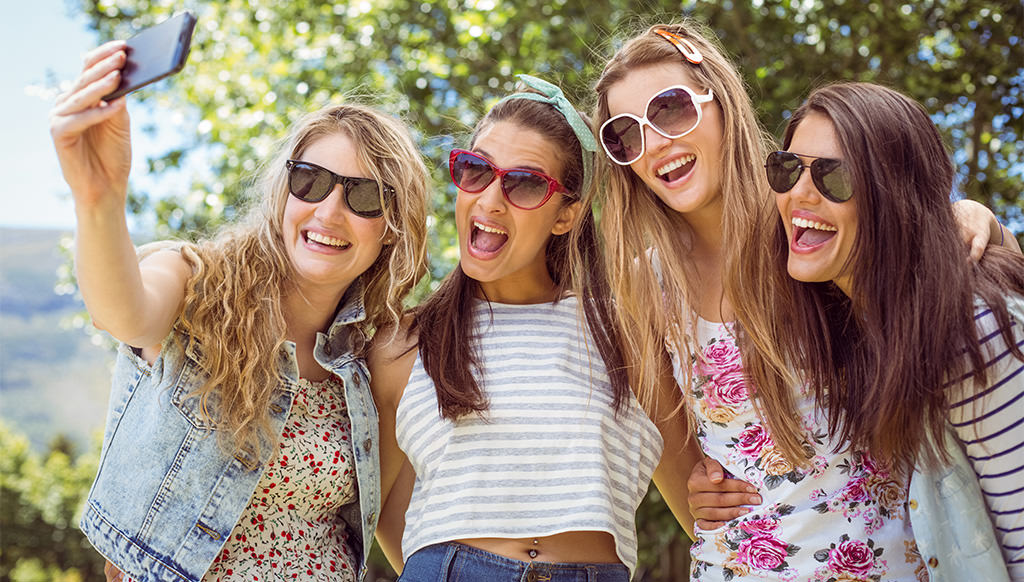 four girls posing for a selfie at a bridal shower. This is for the article called best bridal shower captions for instagram