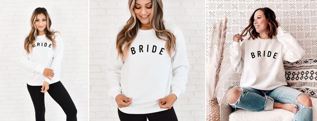 A bride wearing a sweatshirt that says bride