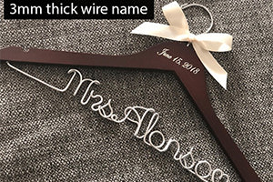 A personalized wedding dress hanger made of wire.