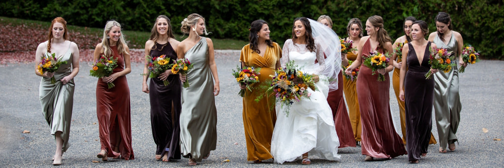 A bride and bridesmaids walking down the street together. This is for the best will you be my bridesmaid proposal ideas article.