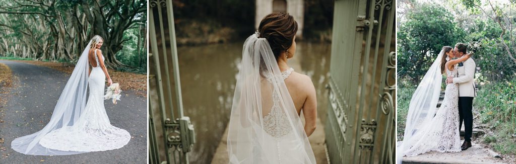A bride wearing a catherdral length veil. She is posing in the woods.