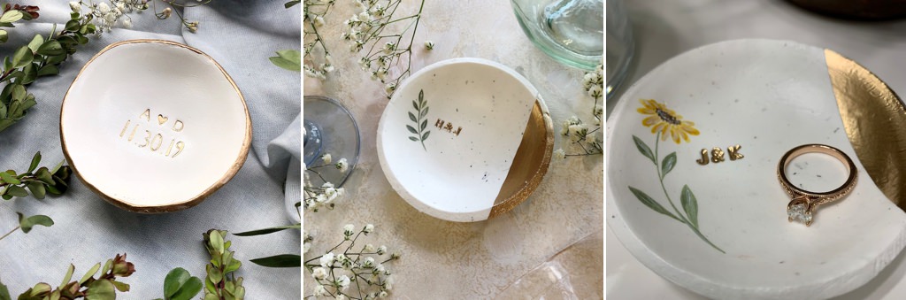 jewelry dish sitting on a table with small flowers around it
