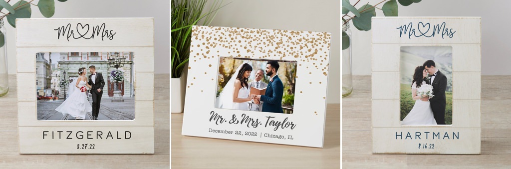 Three wedding photo frames on a table