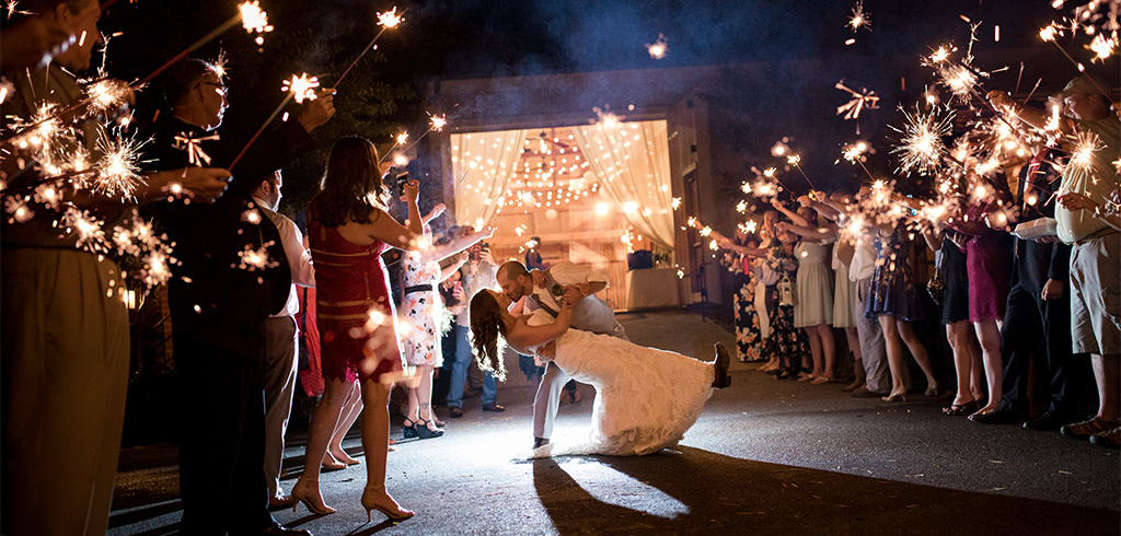 A couple doing a sparkler exit after their wedding reception