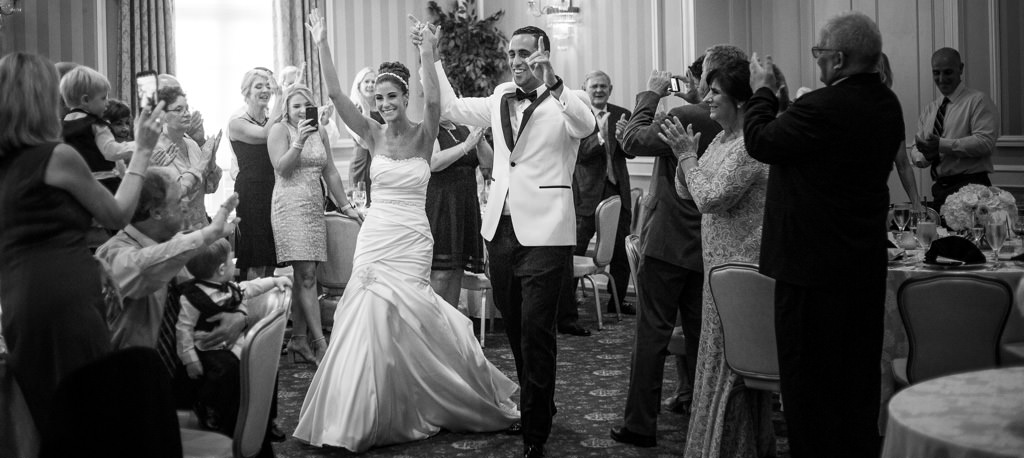 A bride and groom being introduced into their wedding reception. This is for the article called wedding reception order of events