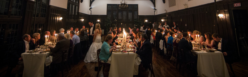 A wedding reception ser up with long tables and candles.