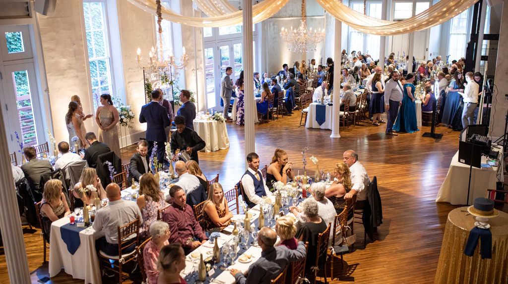 A scene at a wedding reception with the guests eating dinner