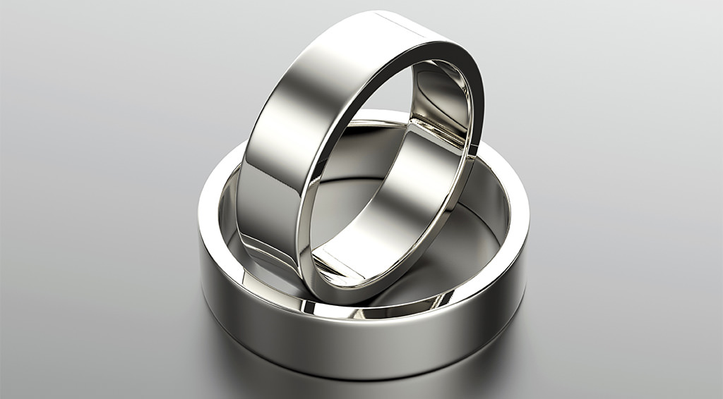 two weddings bands for men on a table. This is for the article called best material for men's wedding bands.