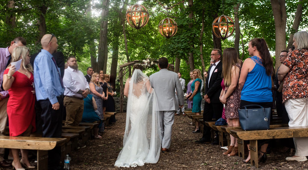 A bride and her father walking down the aisle. This is for the article called best acoustic wedding songs.