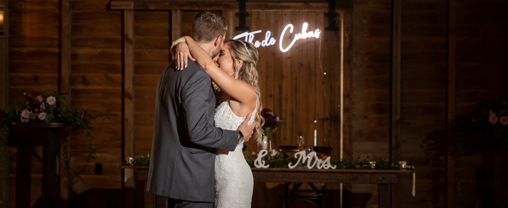 A bride and groom doing their first dance to an acoustic song