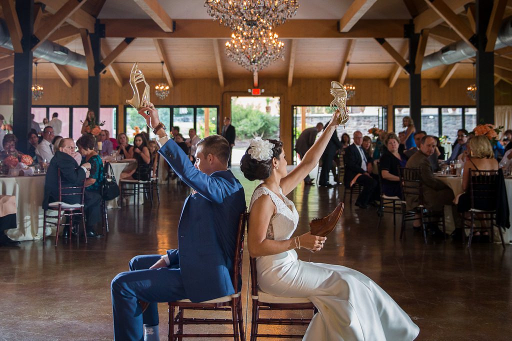 A bride and groom playing the shoe game at a wedding reception.