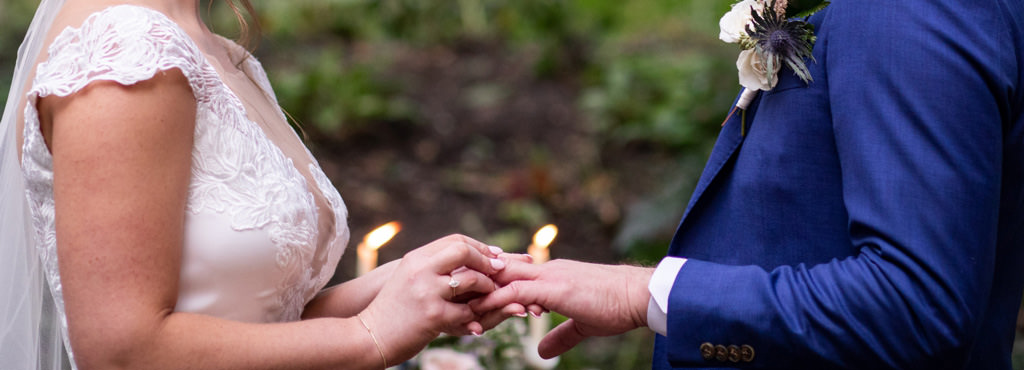 A bride wearing her engagement ring on her right hand during the wedding ceremony. This is for the article called do you wear your engagement ring down the aisle.