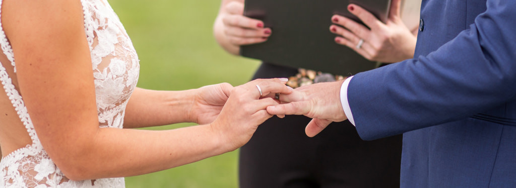 A bride wearing her engagement ring on a different hand during the ring exchange.