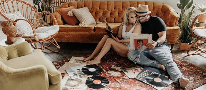 A couple listening to records on the floor. This is the cover photo for the article called date night ideas and late night activities for couples