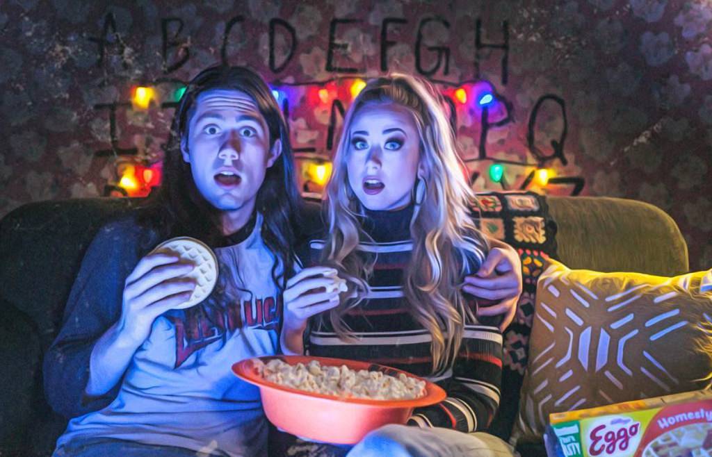 A couple watching Stranger Things on Netflix for a date night