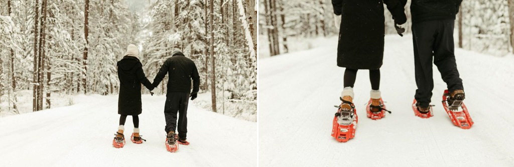 A couple snowshoeing and holding hands