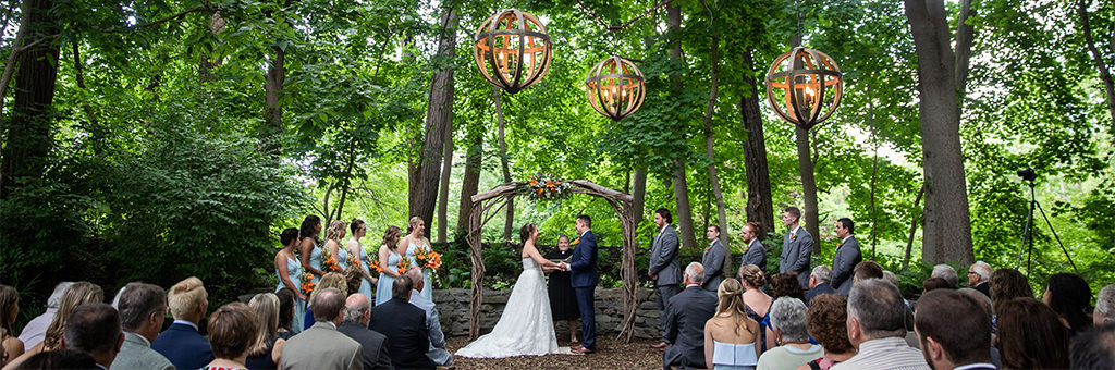 An outdoor wedding ceremony taking place at a beautiful wedding venue.