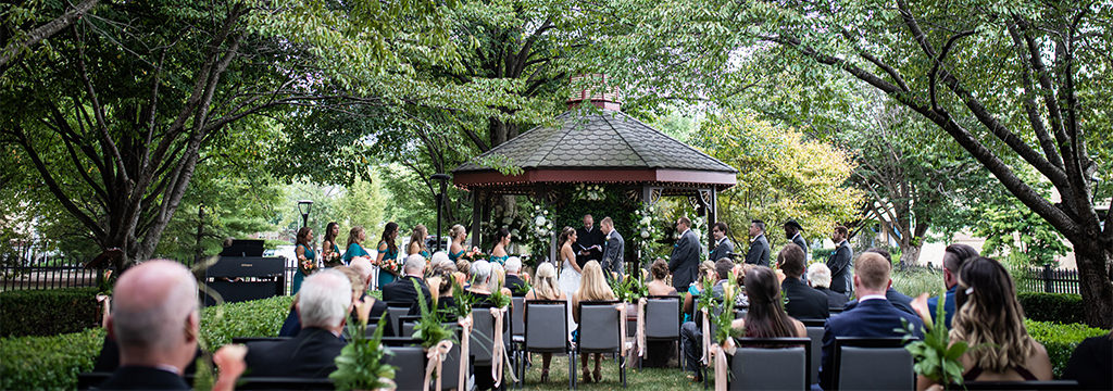 A wedding venue ceremony site. A bride and groom are getting married outside.