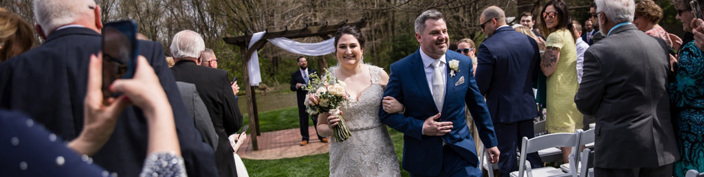 A bride and groom walking back down the aisle during the wedding recessional