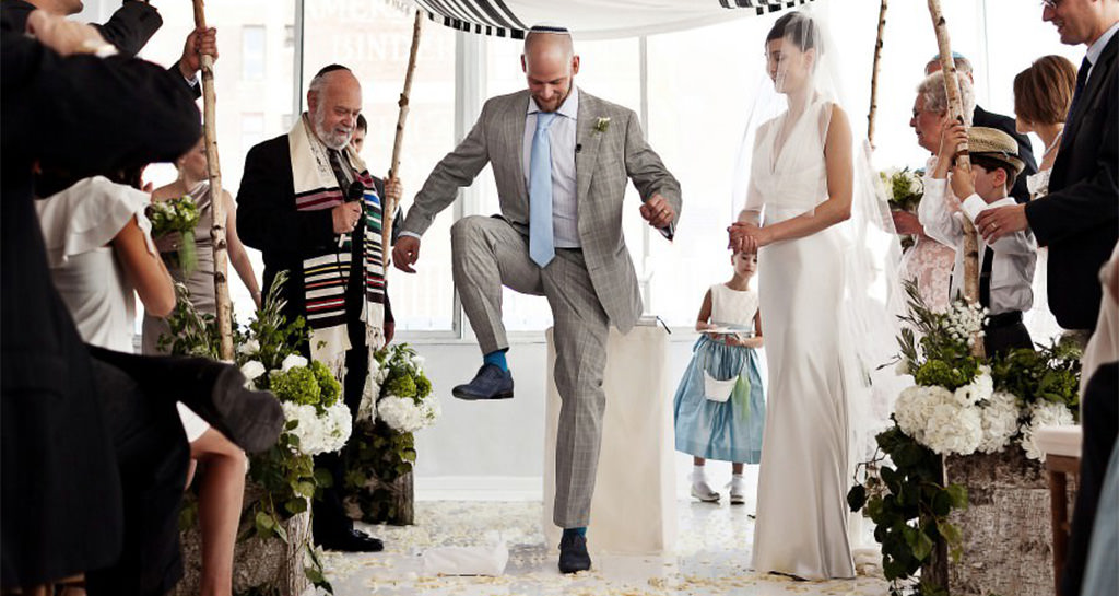 A Jewish wedding ceremony. The groom is breaking the glass.