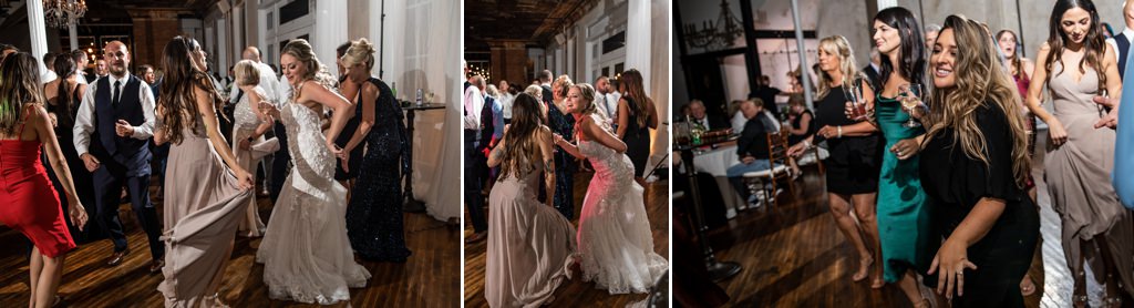 A bride and wedding guests dancing to music during the wedding reception