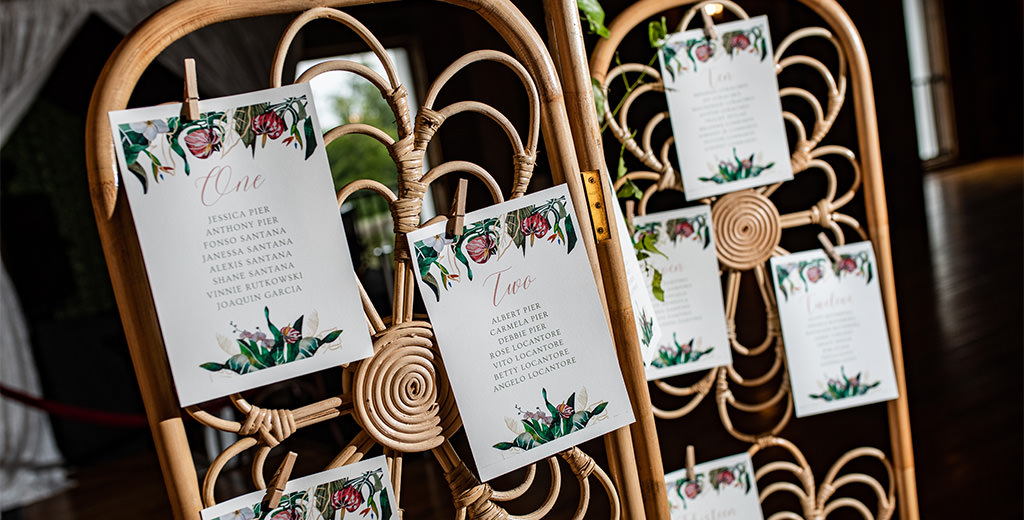A set of DIY wedding seating chart cards hanging up in the wedding reception room.