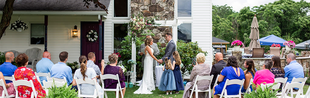 A couple getting married in a backyard.