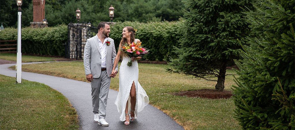 A bride and groom walking down a path. This is for the article called how to pay for a wedding.