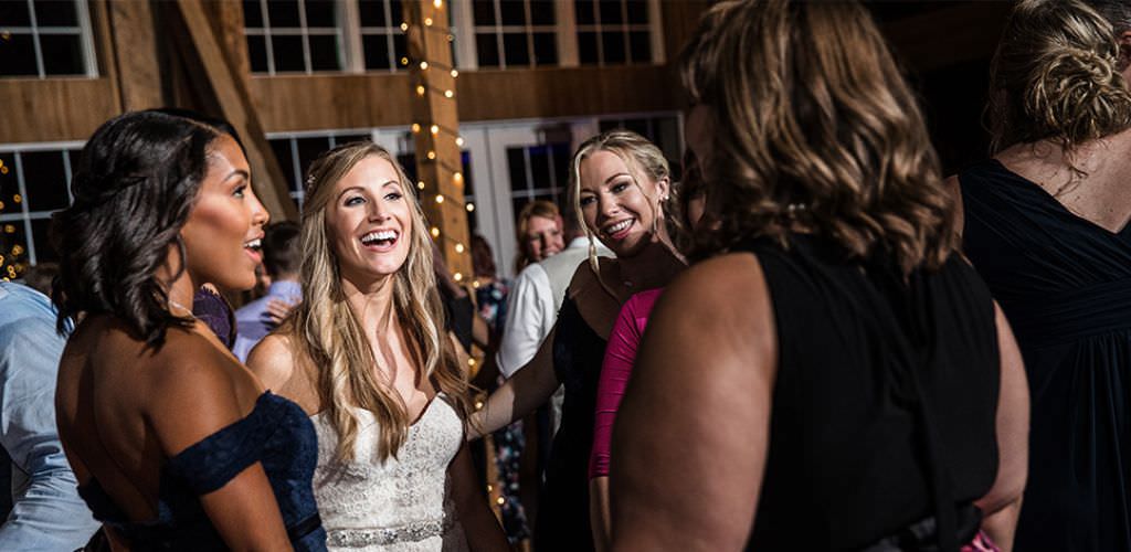 A bride and Maid of Honor dancing at the wedding reception together