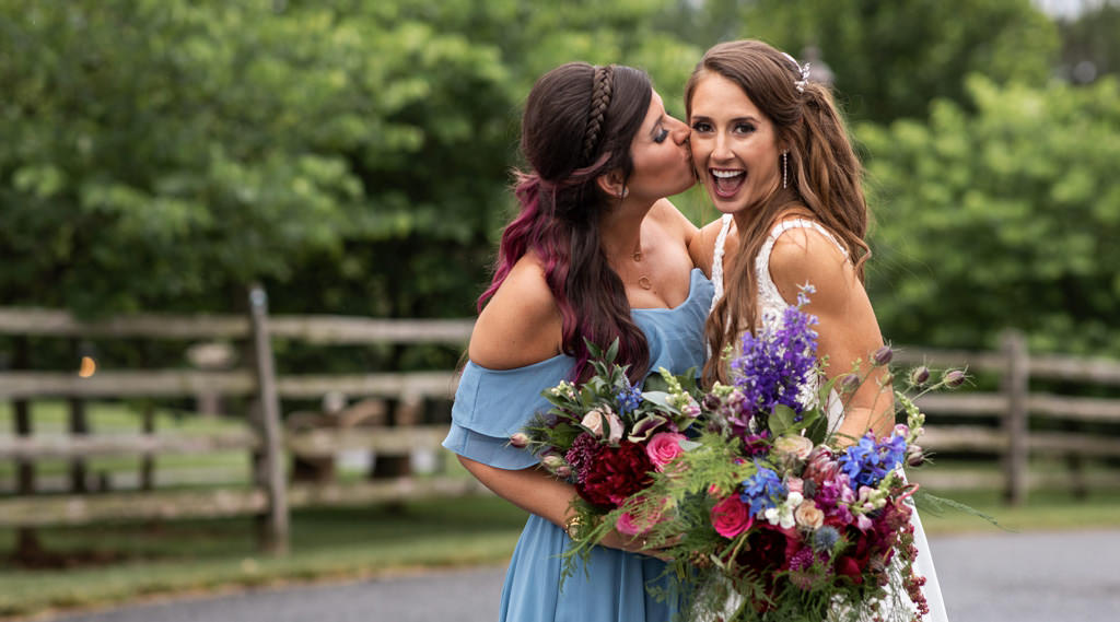 A Maid of Honor kissing the bride on the cheek. This is for the article called Maid of Honor Duties - Matron of Honor Responsibilities.