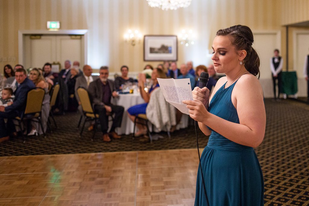A Matron of Honor giving her speech at the wedding reception.
