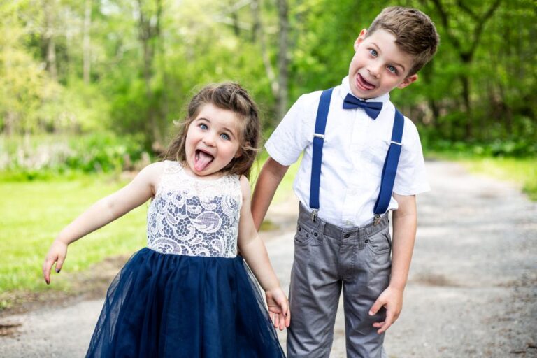 A funny flower girl and ring bearer making faces