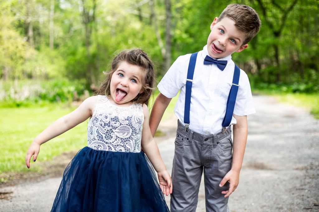 A funny flower girl and ring bearer making faces