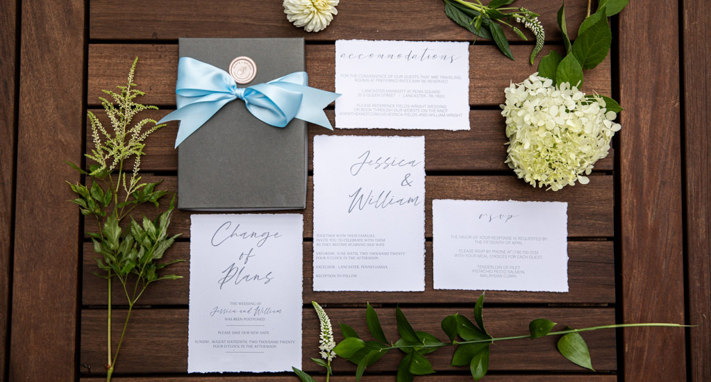 A wedding invitation and save-the-date card with flowers