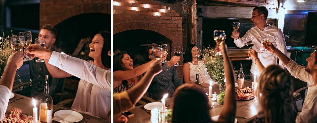 A wedding rehearsal dinner showing guest raising glasses as someone gives a toast