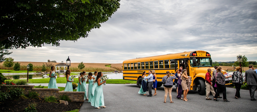 A wedding that used a school bus for transportation. This photo shows the wedding party guests getting off the school bus