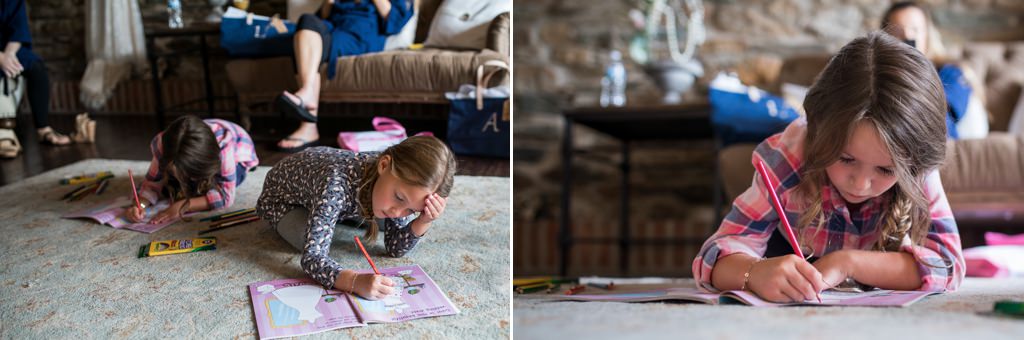 Two flower girls coloring in a wedding day activity book while the bride and bridal party get ready