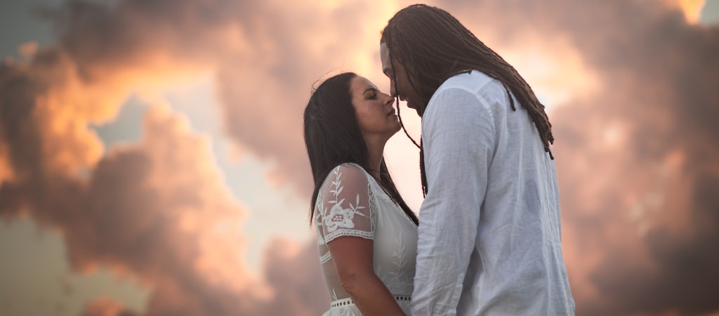 A couple posing for photos on their honeymoon