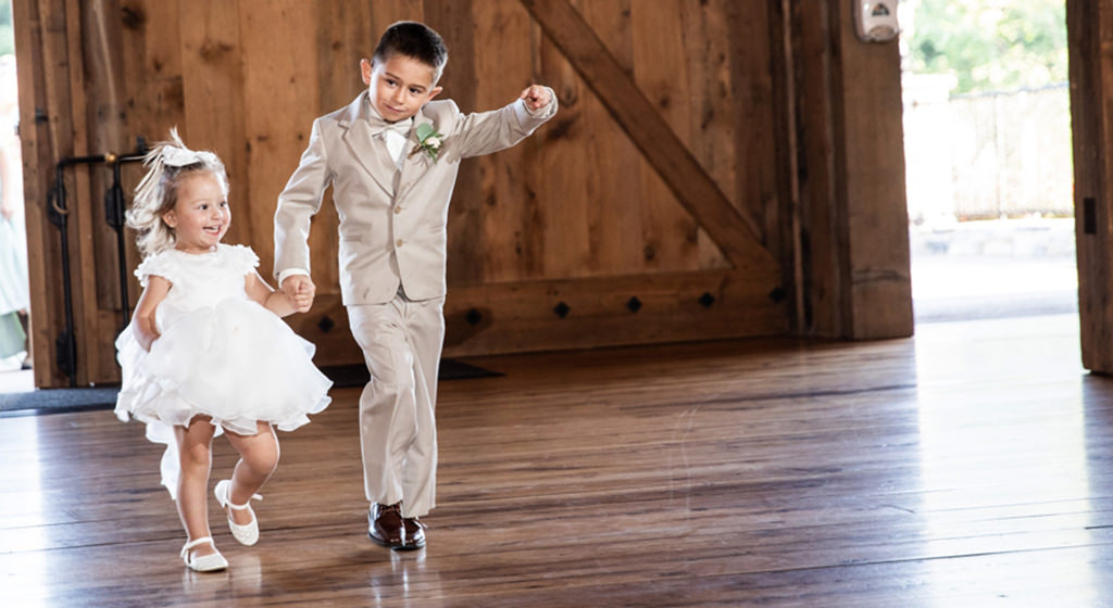 A ring bearer and flower girl entering the wedding reception to some fun upbeat music
