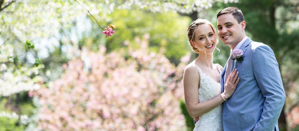 A bride and groom posing after their spring wedding in May