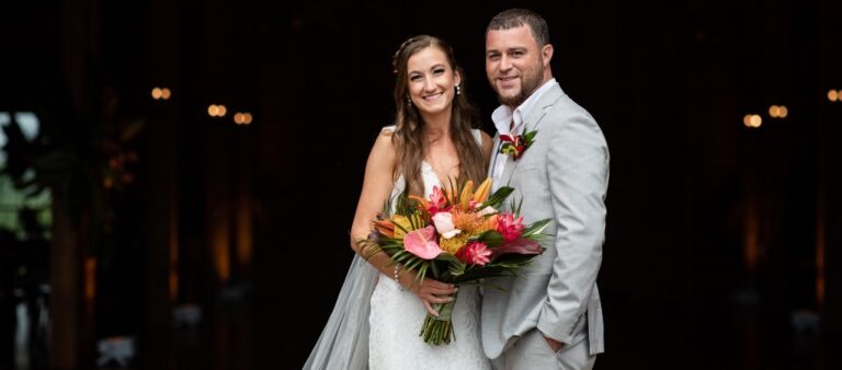 A bride and groom posing and looking at the camera