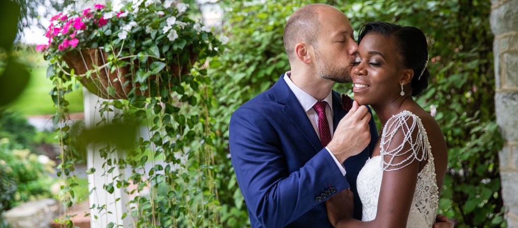 A groom kissing the bride on the cheek