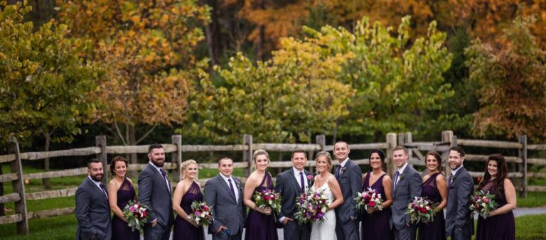 A wedding party posing after a fall wedding. This is a photo used for the article called the best month to get married