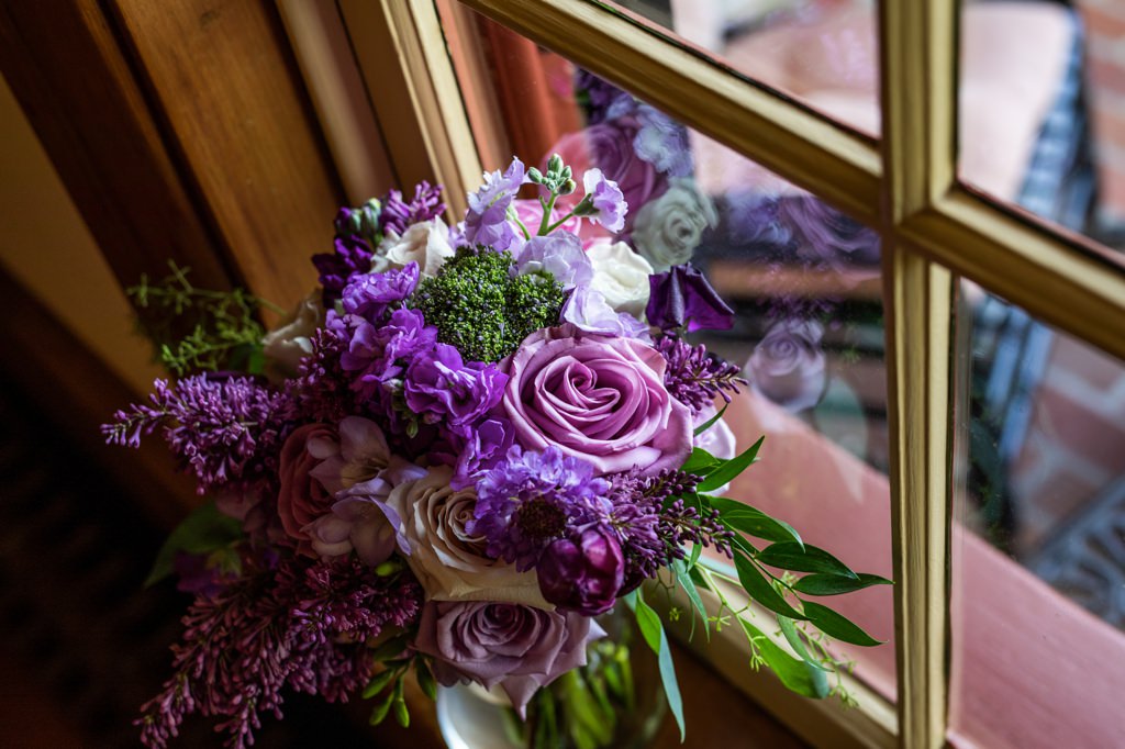 A purple bridal bouquet in the window