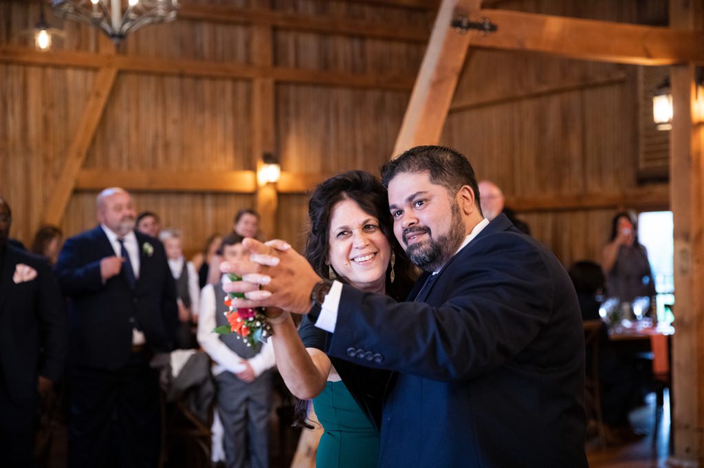 A groom and his mom dancing together at the groom's wedding