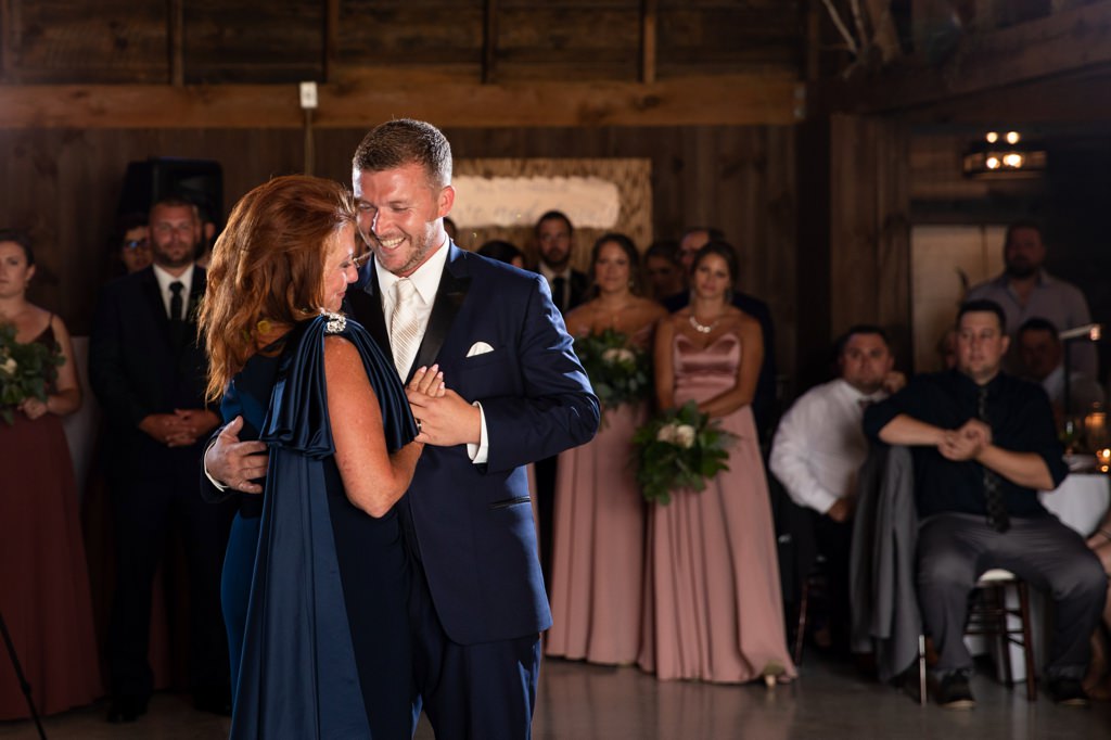 A groom showing how much he loves his mom as they dance together.