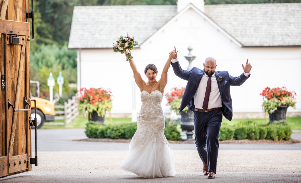 A bride and groom entering the wedding reception. This is for the article called how to introduce the wedding party at a reception