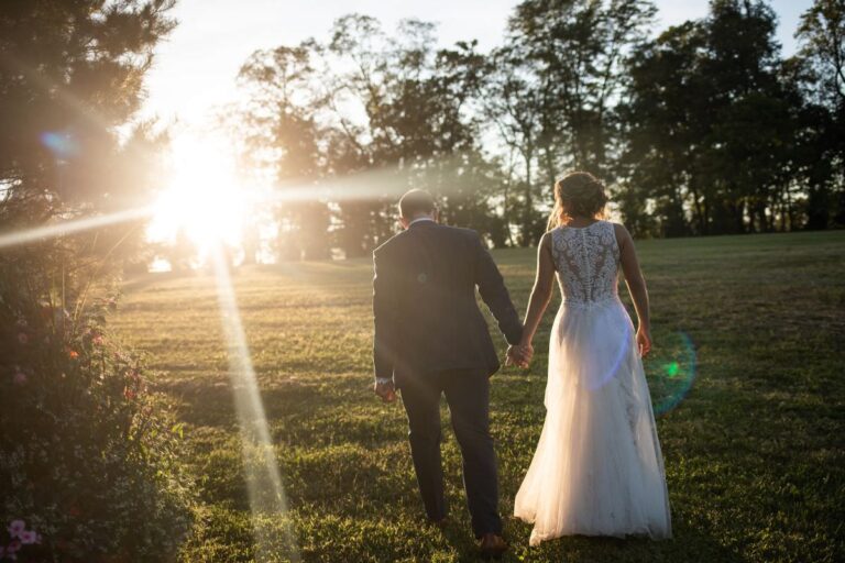 A bride and groom walking at sunset. This is the first article for the blog post called how to plan a wedding for $1,000