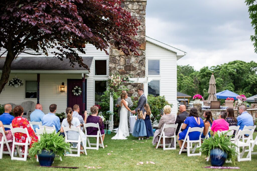 A bride and groom getting married at a backyard wedding